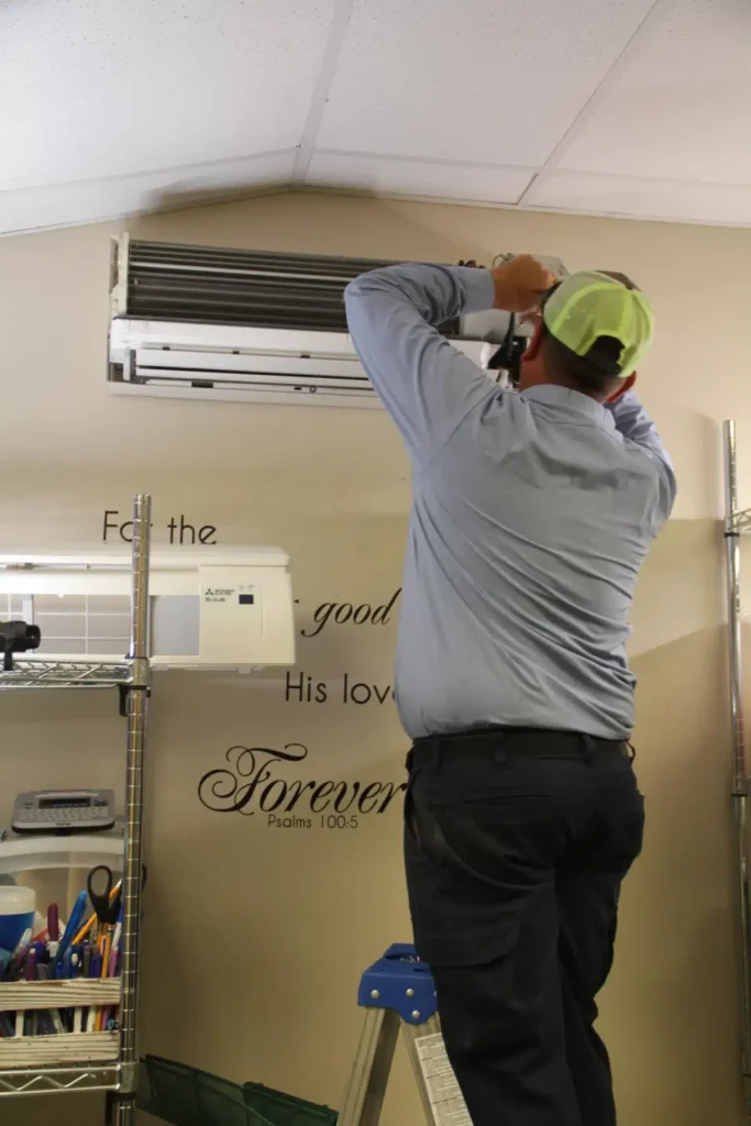 What is SEER Rating? 3 Man doing maintenance on air conditioning unit