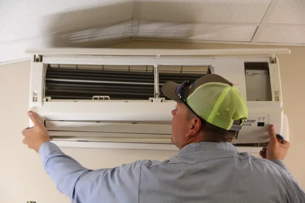 HVAC worker installing AC unit