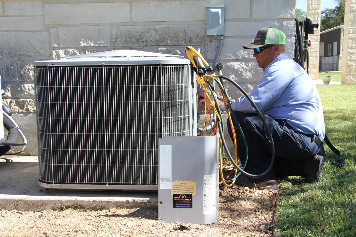 How Long Does an HVAC System Last? 3 HVAC worker doing maintenance on AC unit