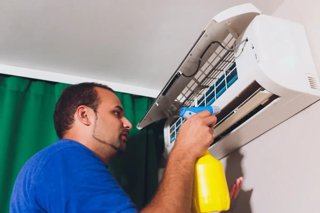 male technician cleaning air conditioner indoors service 1 1
